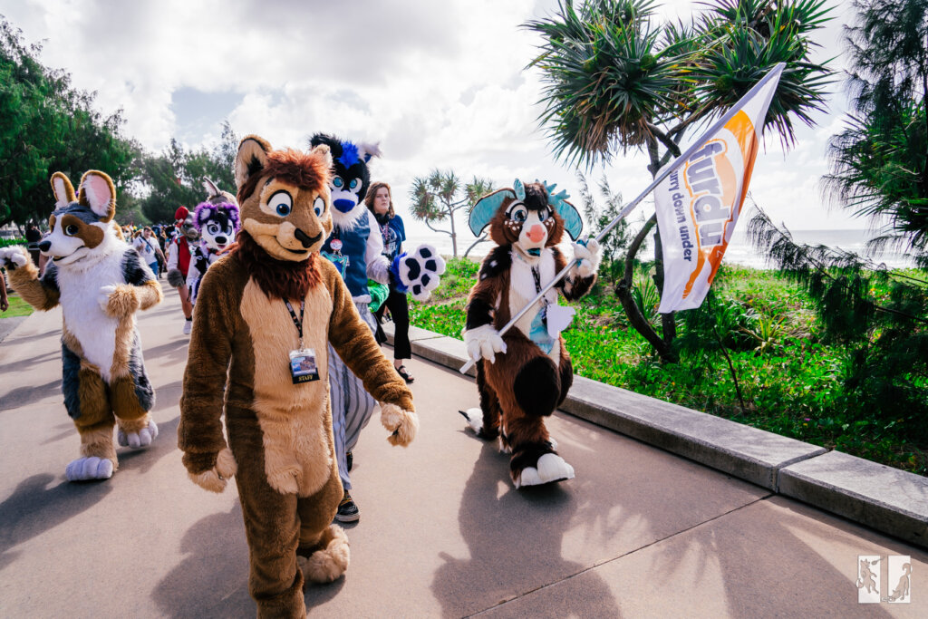 fursuiters going on a "fursuit walk" one on the right is holding a "furdu" flag